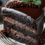 Decadent Midnight Fudge Cake topped with rich chocolate ganache.